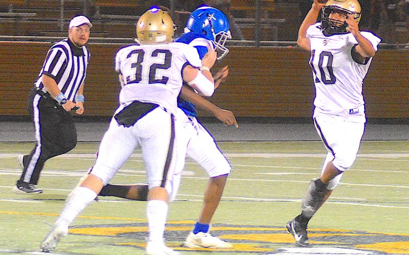 Gary Corsair • Clay County Progress Hayesville quarterback Cole Vining, No. 10, rolls out to pass as Dawson Devane, No. 32, provides protection.