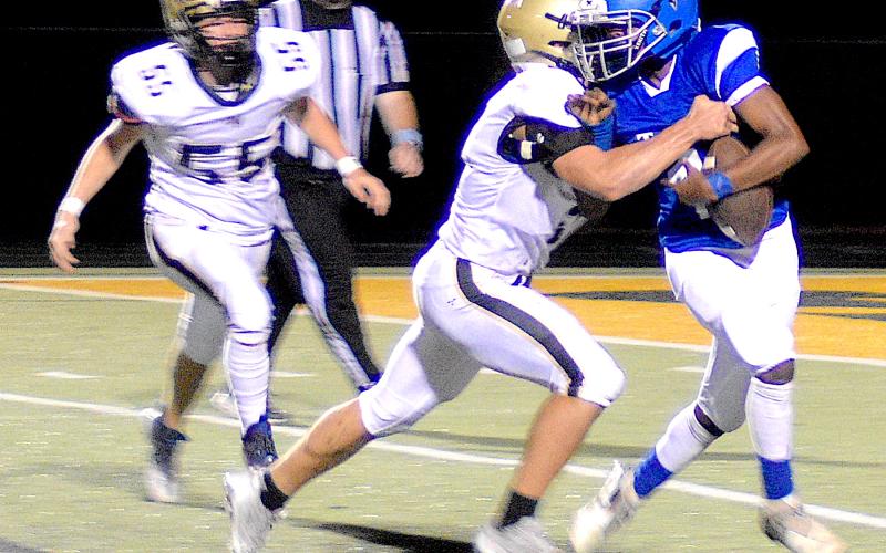 Gary Corsair • Clay County Progress Seth Leek, No. 9, drives New Faith's quarterback backward for a big loss.