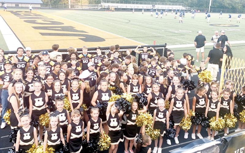 Youth cheerleaders and football players