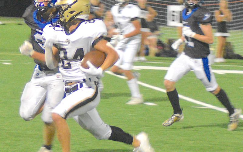Gary Corsair • Clay County Progress Hayesville spark plug Michael Mauney, No. 24, shifts into high gear and leaves Georgia Force defenders in his rear-view mirror on the way to a touchdown. Mauney rushed for 68 yards and made a team-high six tackles.