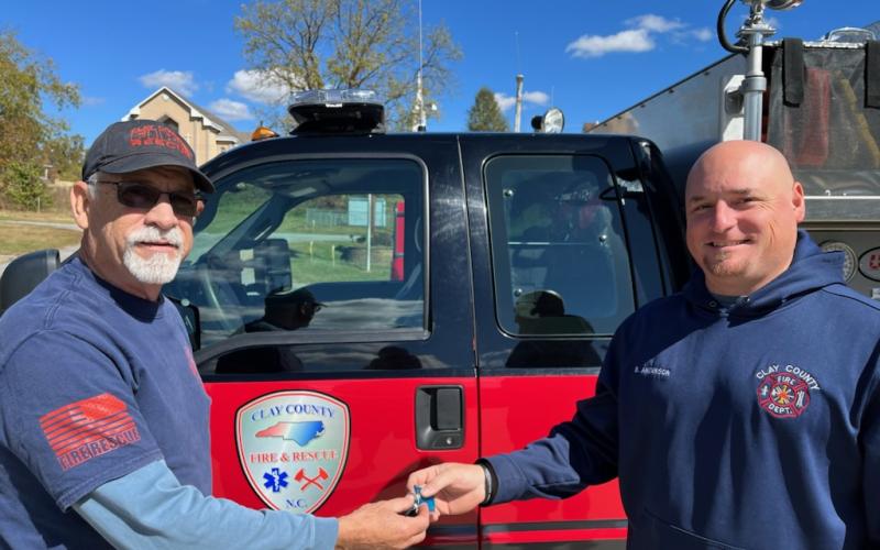 Battalion Chief Pete Trocchia gives Chief Brian Anderson the keys to the Wildland and Rescue Vehicle.