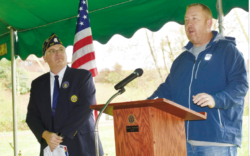 American Legion Post 532 Commander Robert Seibert listens as County Commission Chairman Rob Peck talks about the future Veterans Memorial Park.