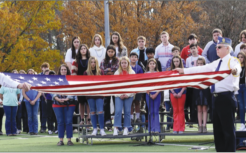 Gracie Taylor • Clay County Progress American Legion veterans Dwight McClure, left, and Phil Cantley conduct the flag folding ceremony at Frank R. Long Memorial Stadium on Nov. 9 during a celebration ceremony in which Hayesville High School, Middle School and Elementary were individually recognized as Patriotic School of the Year in North Carolina. “This is a big deal,” noted Legion member Carl Maxwell. “It’s a statewide honor and all three of our schools were recipients.”