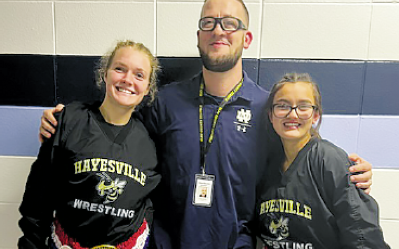From right, Lakota ‘Star’ Shelton, Coach Daniel Sherlin and Amyna Denton take home awards from wrestling tournament.