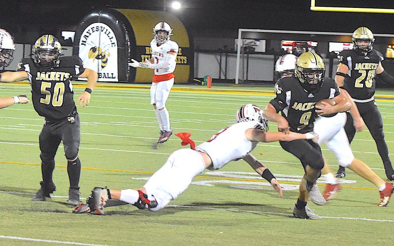 Gary Corsair • Clay County Progress Hayesville's Seth Leek, No. 9, finds room to run thanks for blocking by E.J. Abrams, No. 50.