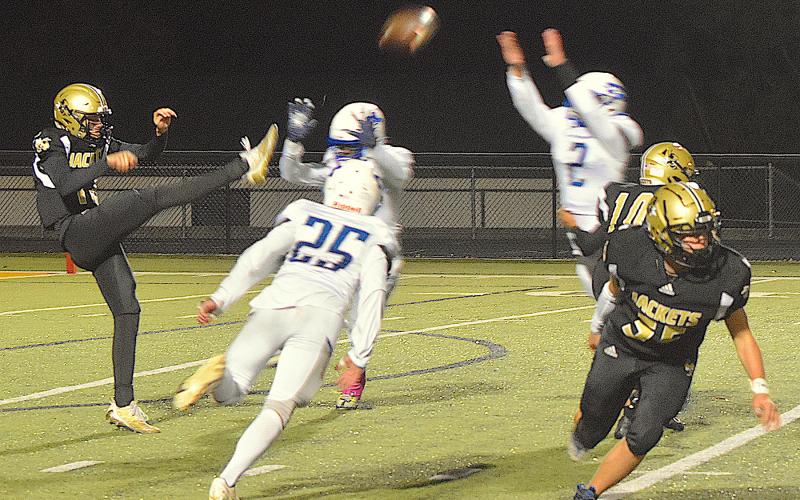 Gary Corsair • Clay County Progress Hayesville freshman Lance Coker, No. 12, keeps his cool as he kicks the ball over three Christ The King defenders. Coker boomed two punts for a total of 72 yards in his varsity debut as a punter.