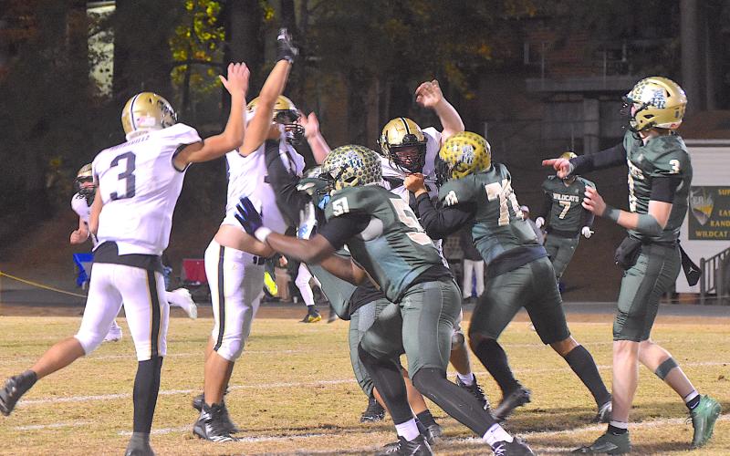 Gary Corsair • Clay County Progress Some people would describe the blocking of Eastern Randolph's linemen as holding on this pass play, but the officiating crew didn't blow the whistle when two Wildcats grabbed the jerseys of Hayesville's trench-men as Jacob Jones, No. 3, arrived on the scene.