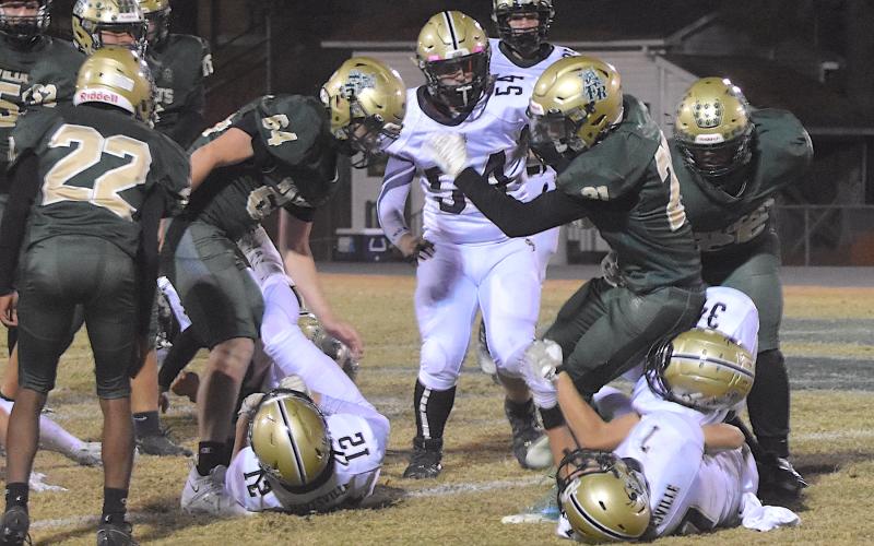 Gary Corsair • Clay County Progress Hayesville defenders Eli Jack, No. 7, and Maverick Imlay, No. 34, drop an Eastern Randolph back for a loss as Yellow Jacket Nathaniel Dockery, No. 54, prepares to pounce.