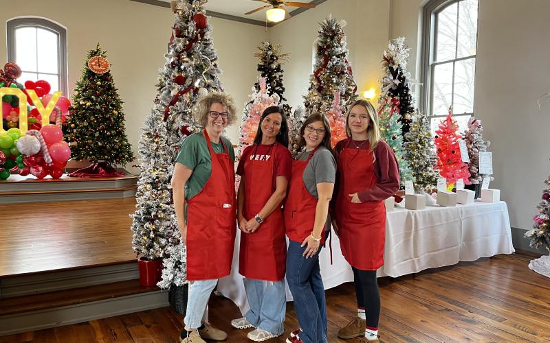 Deby Jo Ferguson • Clay County Progress Festival of Trees, making it come together from left, Tracy Cothren, Amanda Wagoner, Michelle Moore and Adeison Sorrells.