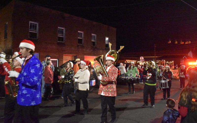 Christy Guthrie • Cherokeee Scout Spectators clap as the Hayesville High School Marching Band makes its way through the streets of Hayesville for Saturday’s Christmas Parade. The band was among the highlights of event.