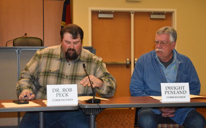 Commission Vice Chairman Randy Nichols reviews a summary of the county’s audit report as Commissioner Dwight Penland looks on during the Jan. 4 monthly meeting. Nichols credited county employees for helping the county receive high marks on its audit.