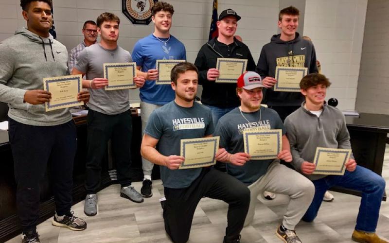 Athletes, front from left, Seth Leek, Dawson DeVane and Michael Mauney, back, Will Brown, Tre Graves, Taylor McClure, Lane O’Dell and Isaac Chandler received recognition at the Clay County Schools Board of Education meeting from Coach McClure for their individual and superior performance in football.
