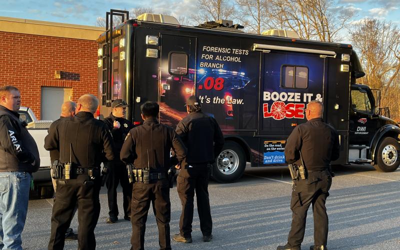 Deby Jo Ferguson • Clay County Progress Officers looking over the portable testing station which traveled to all set up stations on Dec. 31 in a joint effort to make the streets safer due to DUIs that could occur during the New Year’s Eve celebration .