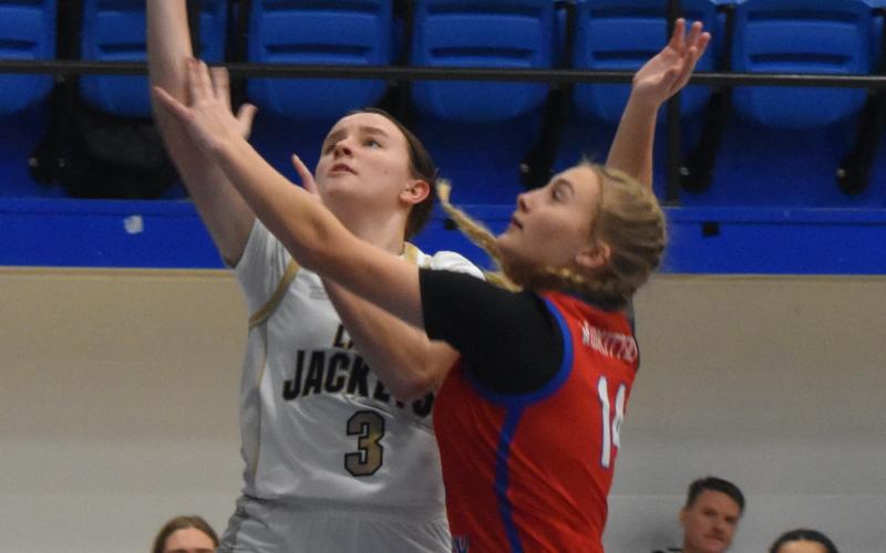 Gary Corsair • Clay County Progress Yellow Jackets guard Jasmine Brooks, No. 3, scores on a layup in Hayesville's convincing win against Polk County.