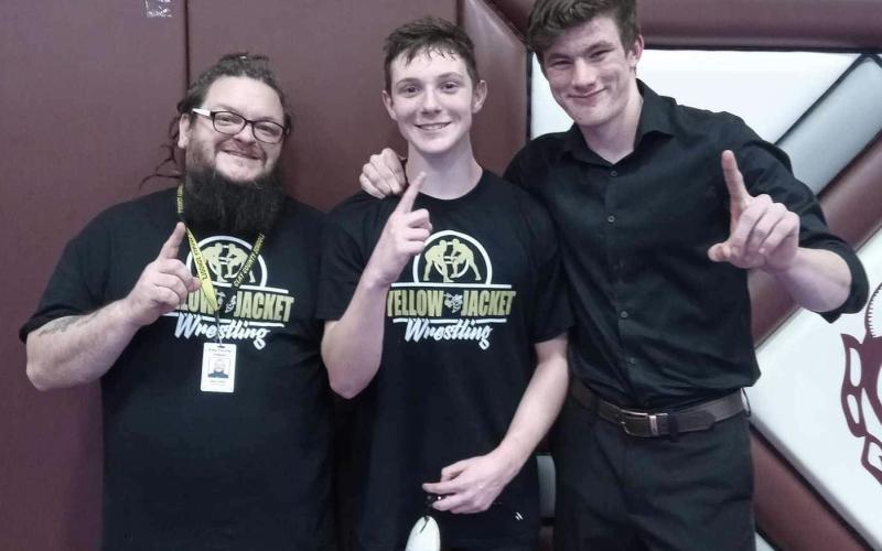 From left: Coach James Denton, Brett Hanna and Coach Jacob Handy after Hanna wins the Smoky Mountain Conference.