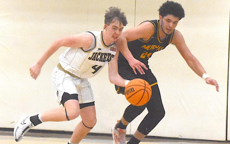 Hayesville's Luke Lee, No. 4, starts up court as Murphy's Dominick Rummel gives chase.