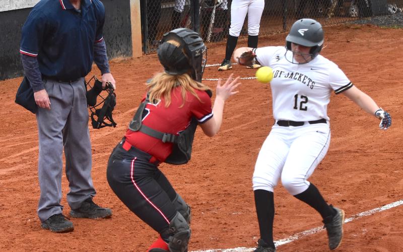 Gary Corsair • Clay County Progress Hayesville freshman Lillie McClure, No. 12, tries to beat a throw home against Pisgah.