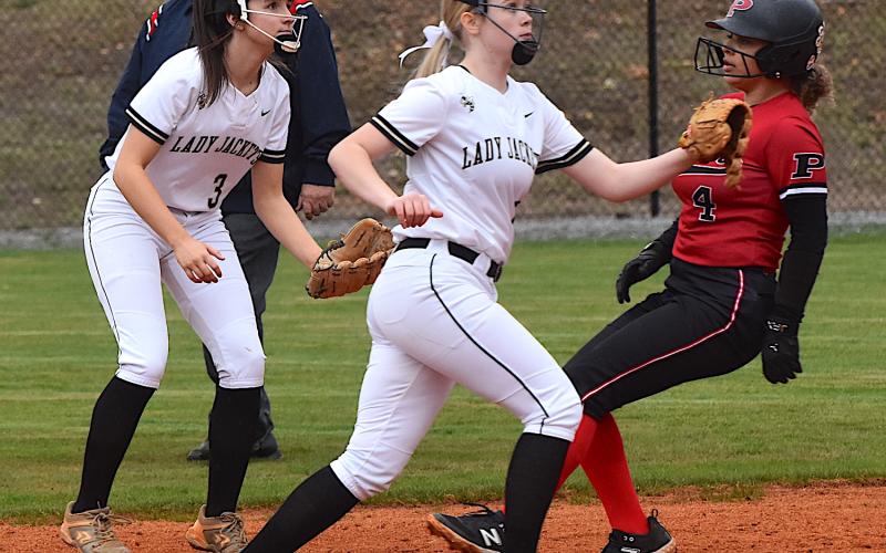 Gary Corsair • Clay County Progress Jasmine Brooks, No. 3, and Junior Raylyn Taylor, No. 11, await the throw from the plate during a Pisgah steal of second.