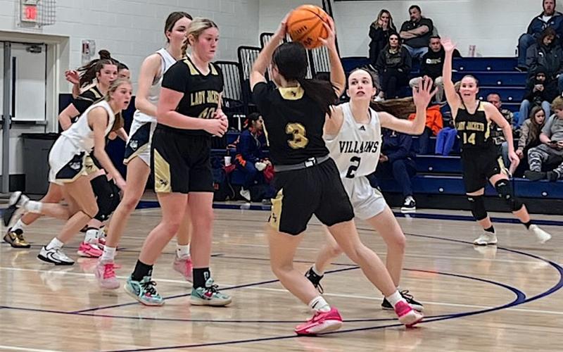 Photo by Beth Chandler Briley Clampitt, No. 14, calls for the ball as Brooke Graves, No. 40, comes up to set a screen as Jasmine Brooks, No. 3, quarterbacks the Hayesville offense against Bishop McGuinness.