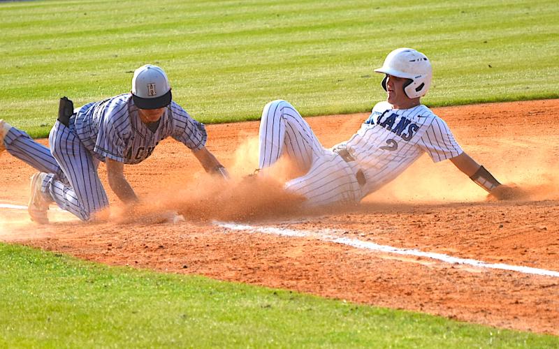 Gary Corsair • Clay County Progress Hayesville third baseman Chance Hughes lunges to tag a base runner during a fifth inning rally by Towns county. The nearest umpire ruled that Hughes made the tag in time, much to the consternation of Towns County coaches, players and fans.