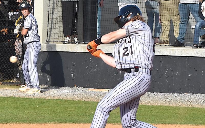 Gary Corsair • Clay County Progress Hayesville's slugging first baseman Jackson Sellers, No. 21, rips a Towns County fastball.