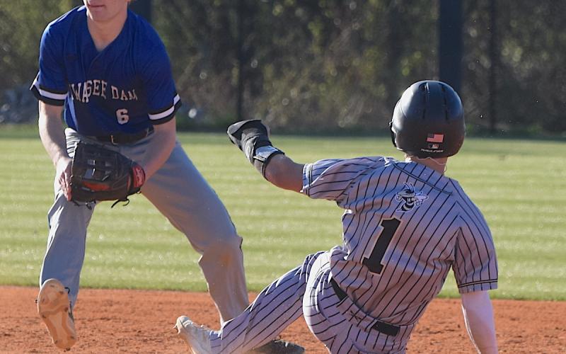 Gary Corsair • Clay County Progress Hayesville speedster Michael Mauney, No. 1, slides into second base ahead of the throw from the Hiwassee Dam catcher.
