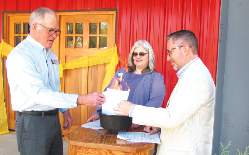 Lorraine Bennett • Clay County Progress Hinton Center, from left, Chief Financial Officer John Nicholas, President and CEO Dr. Jacqueline Gottlieb and Board of Directors Chairman Rev. Dr. Tim Moore burn the building’s note.