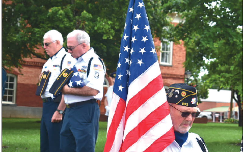 Becky Long • Clay County Progress In the background, Phil Cantley and Mitchell Shields pause for prayer along with Color Guard member Tommy Hooper.