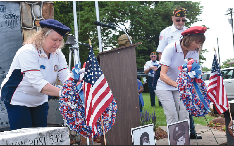 Becky Long • Clay County Progress American Legion Auxiliary member Charlotte Tilley and VFW Auxiliary member Linda Bond conduct the ceremonial placing of the wreaths on the Hayesville monument during Monday’s Memorial Day service.