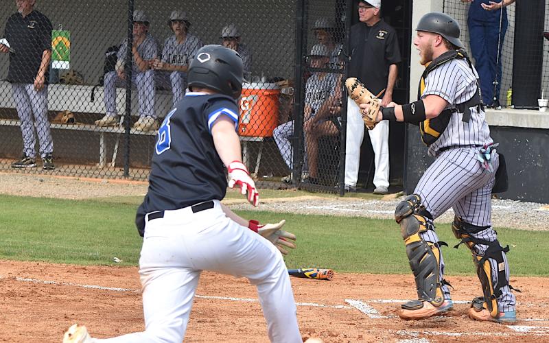 Gary Corsair • Clay County Progress Yellow Jackets catcher Dawson Devane calls for the ball to be thrown to the plate during Bethany Community's 4-run first run.