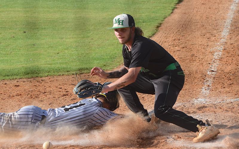 Gary Corsair • Clay County Progress Tate Roberts slides home with Hayesville’s second run on a wild pitch in the seventh inning of the Yellow Jackets second-round playoff game.