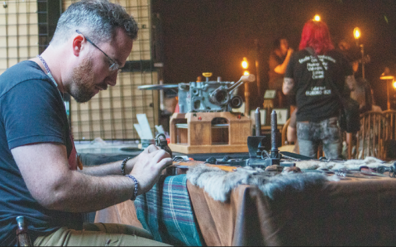 Photo •Stephen Squibb Blacksmith Jesse Bolding polishes the imperfections out of one of his blades.