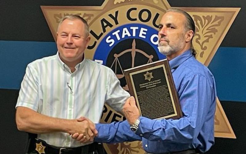Clay County Sheriff Mark Buchanan presents Ed Figueroa with the Appreciation for Exemplary Service award.