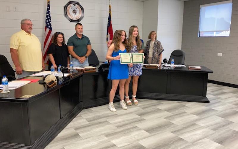 Marcia Barnes • Clay County Progress Board members Danny Jones, Kelly Crawford, Jason Shook and Reba Beck congratulate Hayesville High School students, from left, Brianna Abrams and Reese Segars as they receive All Conference Soccer Honorable Mention certificates from Soccer Coach Mike White.