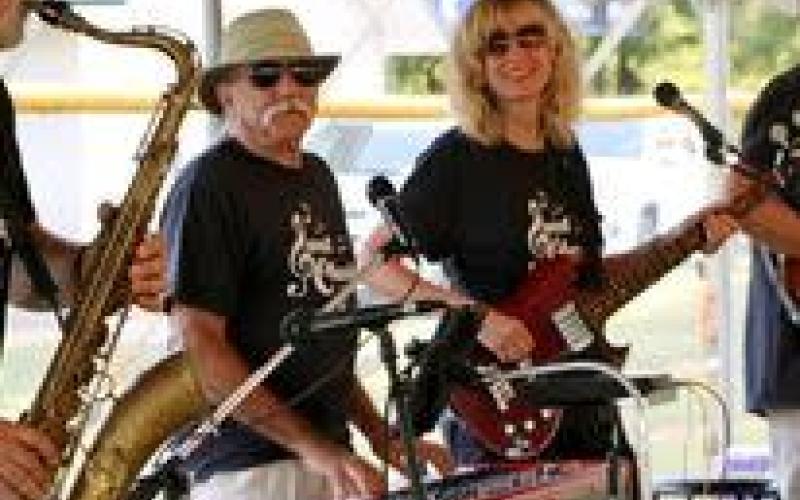 Sweet Charity’s Rockin’ Replay coming to the Hiawassee Square with David Bacon on lead guitar and Karen Bacon on bass guitar.