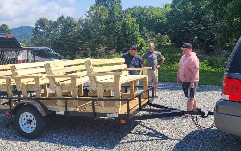 Mount Pleasant volunteers, from left, Bob Storring, Eric Segars, Dan Sams and Garrett Segars load benches to deliver to the historical Indian trail.