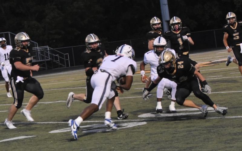 Leeanna Alberta • Clay County Progress  Jacket swarm including No 24 Michael Mauney rushes to take down Asheville's No. 7.