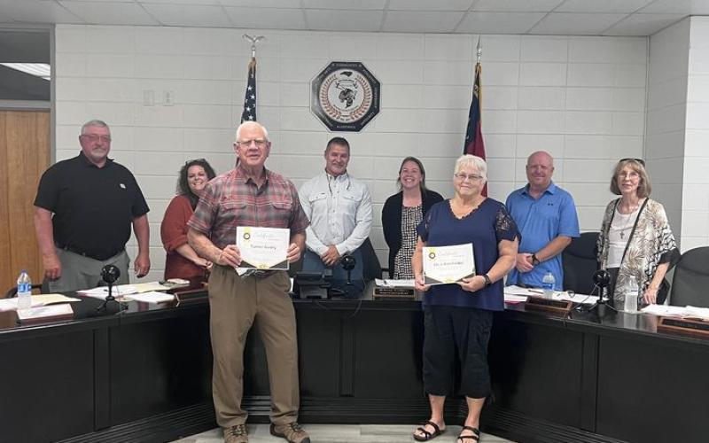 Photo by Angel Owens From left front, Turner Guidry and Chris Batchelder received recognition for exemplary service as substitute teachers in Clay County Schools during the regular board meeting on Monday, Sept. 23. Members of the Board, from left back, are Danny Jones, Kelly Crawford, Chairman Jason Shook, Superintendent Melissa Godfrey, Robert Caldwell and Reba Beck.