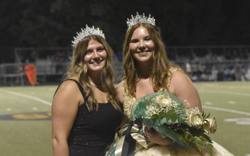 2024 Homecoming Queen Mallory Peck, on right, smiles after being crowned by last year’s queen, Gracelynn Anderson during Friday’s half-time festivities at the football game in Hayesville. Brooke Graves was named runner-up.
