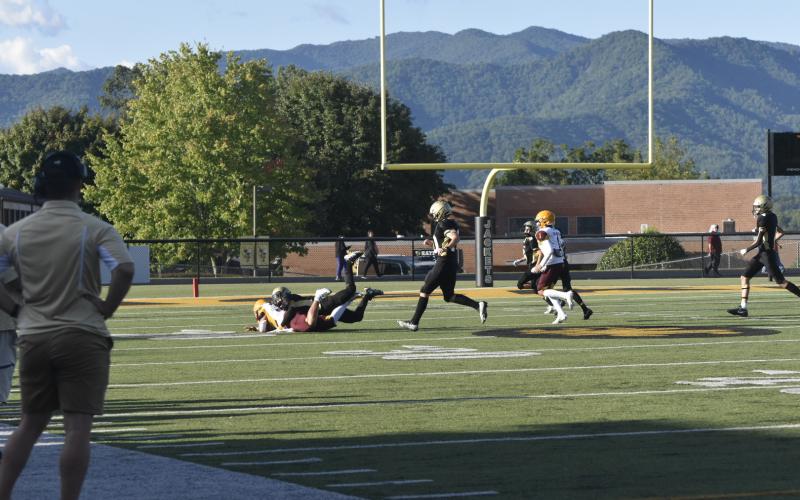 Leeanna Alberta • Progress Brett Hannah, No. 8, on the tackle.