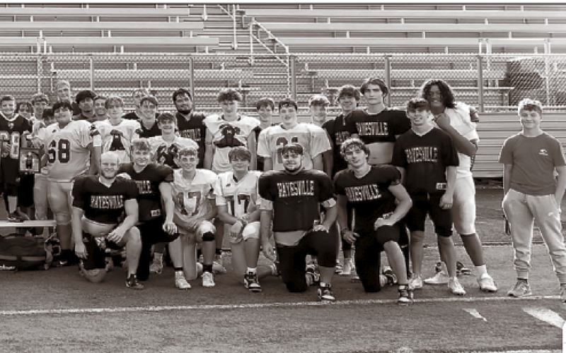 Hayesville Yellow Jacket players of all ages gather recently to pay tribute to the two Rosman teens, Layne Jones and Jayden Reynaldo who lost their lives in an ATV accident on Aug. 25. Some wore the Tiger’s signature orange in support the players and the Rosman community.