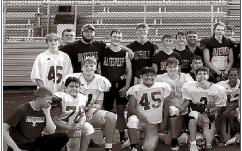 Hayesville Yellow Jacket players of all ages gather recently to pay tribute to the two Rosman teens, Layne Jones and Jayden Reynaldo who lost their lives in an ATV accident on Aug. 25. Some wore the Tiger’s signature orange in support the players and the Rosman community.