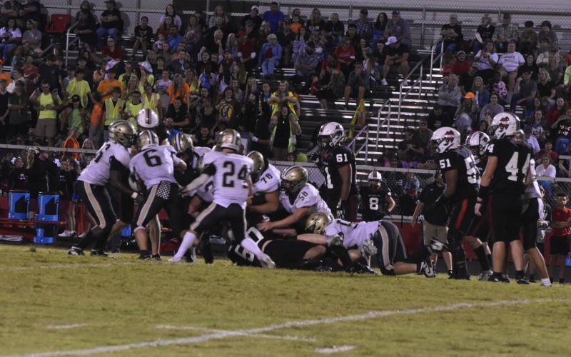Leeanna Alberta • Clay County Progress A Jacket swarm led by Tre Graves, No. 6, and Michael Mauney, No. 24.
