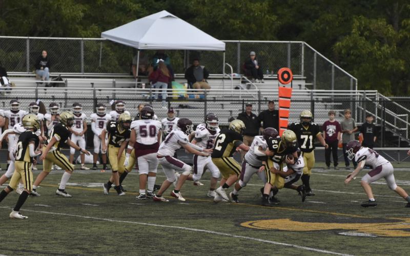 Leeanna Alberta • Clay County Progress Caden McClure No. 20, is taken down while, No.72, Tucker Moore and, No. 71, Jonathan Godinez help fight the defense.