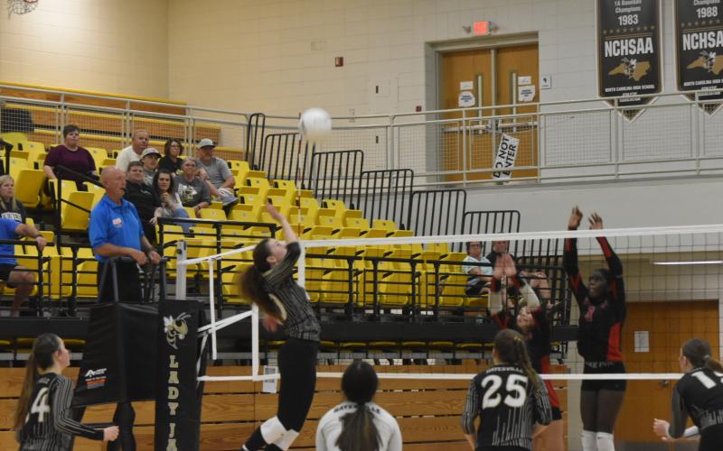 Leeanna Alberta • Clay County Progress Olivia Giddens, No. 20, saving the ball with back up from Phoebe Pietilla, No. 11, and Savannah Burch, No. 25.