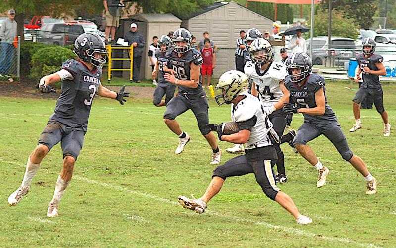 Gary Corsair • Clay County Progress Hayesville's Michael Mauney, No. 24, busts a mighty move on a long-gainer against Concord Christian. Mauney rushed for 105 yards in the Yellow Jackets 37-16 victory.