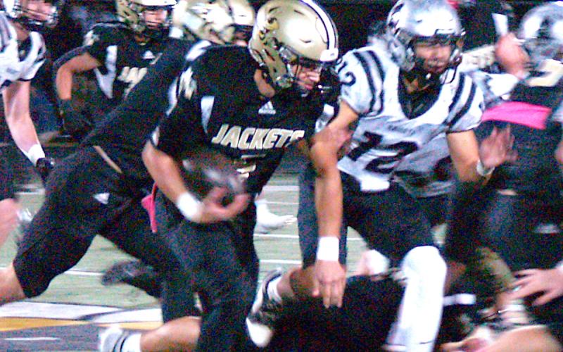 Gary Corsair • Clay County Progress Hayesville's Tate Roberts, No. 5, high tails it around right end for a gain against Robbinsville.