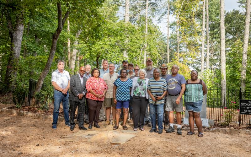 Many people were involved in the preservation work at Freedom Cemetery. According to Pastor Harold Holbrook of Fort Hembree Baptist Church, the recent work has been made possible by the partnership of the Clay County commissioners and a lot of volunteers. Front, from left, Commissioner Scott Penland, Harold Holbrook, Theresa Holbrook, Annie Lloyd, Betty Bradley, Betty Dorsey, Kent Dorsey and Lisa Dorsey; center, Commissioner Clay Logan, Larry Dennison and Lewy Dennison of Dennison Brothers Landscaping; Jole
