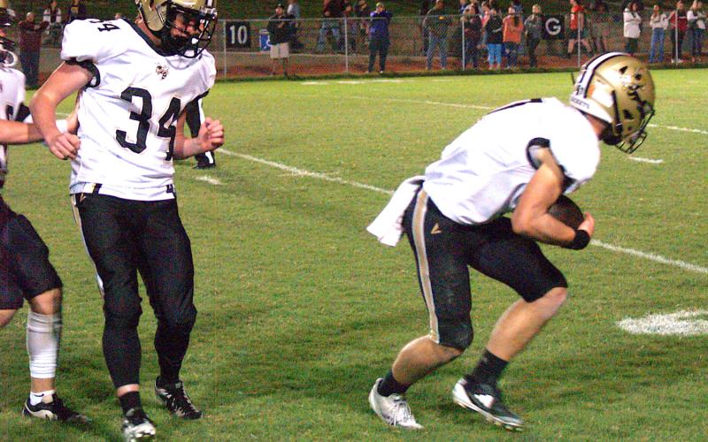 Gary Corsair• Clay County Progress Hayesville's Ben Bethel, No. 1, returns to earth after making an amazing one-handed interception. Silas Lovingood, No. 34, enjoys the view.