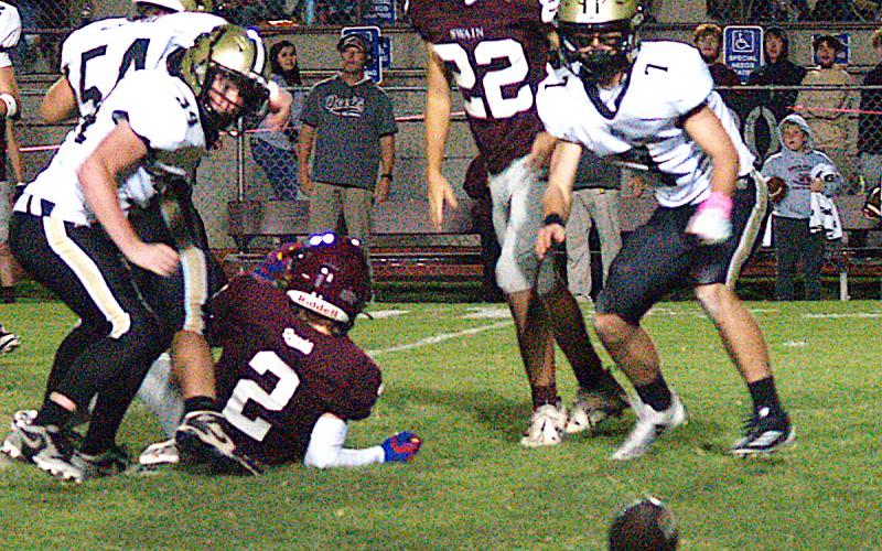 Gary Corsair• Clay County Progress Hayesville's Eli Jack, No. 7, and Silas Lovingood, No. 34, are thinking "fumble recovery" after teammate Matt Gorham, No. 54, dropped a Maroon Devil ball carrier.